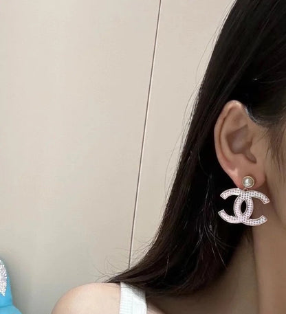 DOUBLE C EARRINGS IN SILVER METAL WITH BLACK SNOWFLAKE EMBOSSED ON WHITE ENAMEL